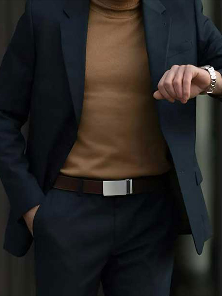 A sleek ratchet belt featuring a textured leather strap with line patterns and a stylish silver buckle.