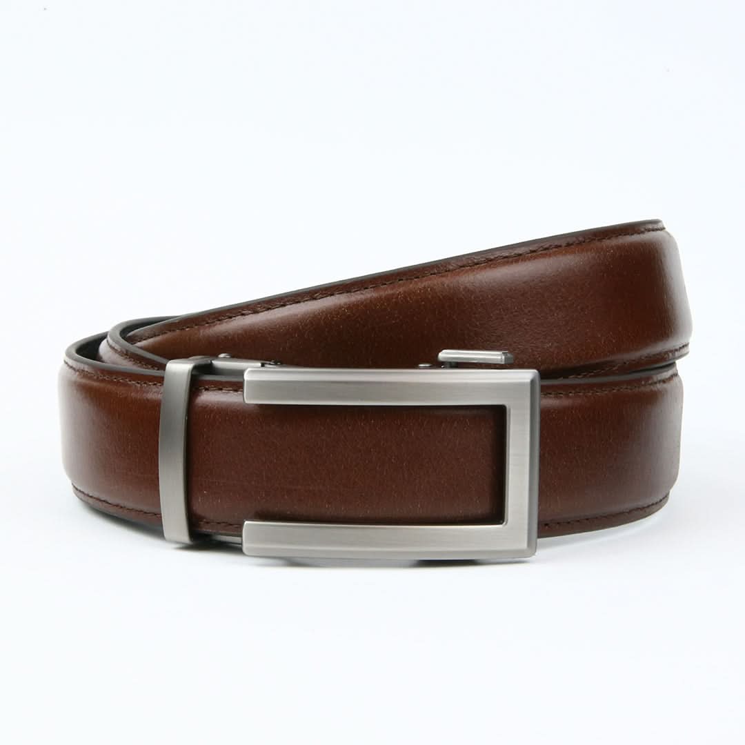 A modern ratchet belt with a smooth tan brown Italian leather strap and a sleek silver buckle.