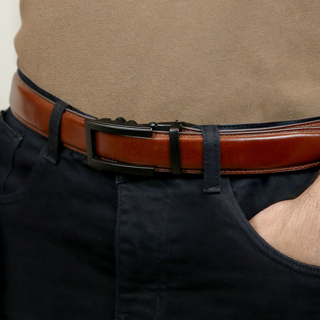 A man showcasing a stylish ratchet belt, featuring a tan brown strap and a sleek black buckle.