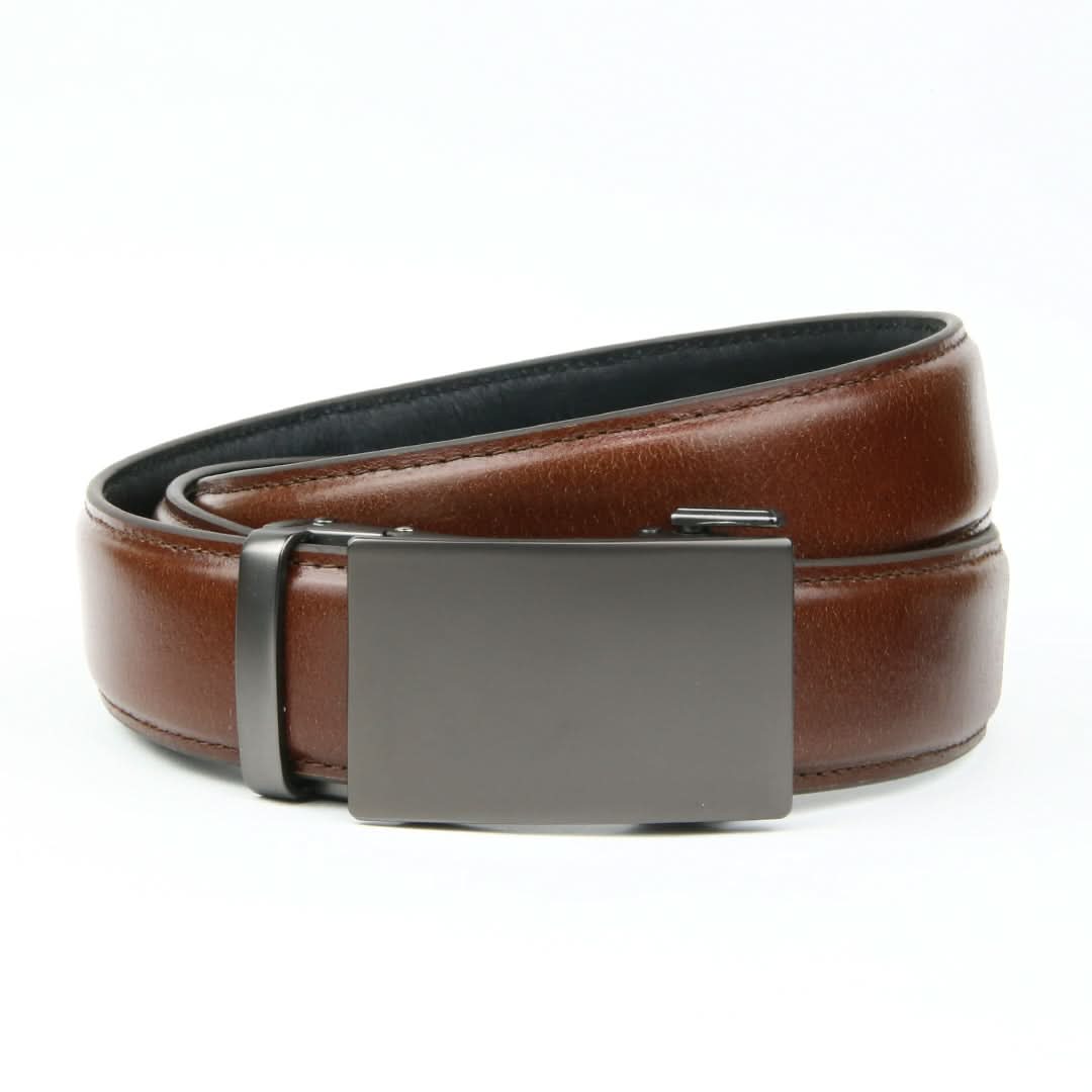 A sleek ratchet belt without holes, boasting a smooth tan brown Italian leather strap and a rectangular gunmetal buckle.